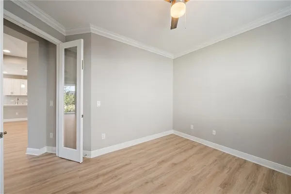 an empty room that has a window and a hallway