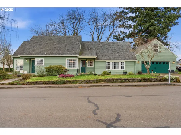 a front view of a house with a garden