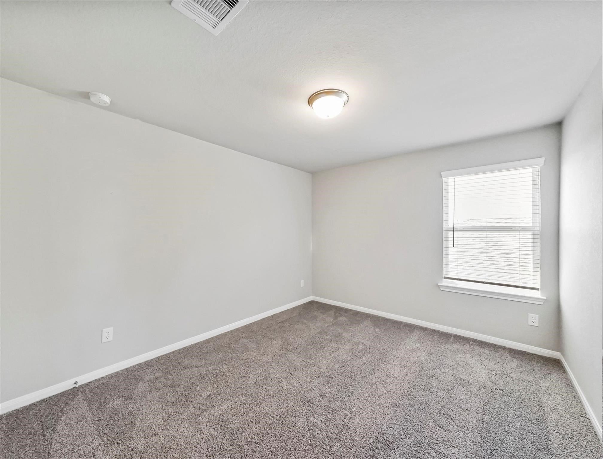 21727 Reserve Ranch Trail Richmond, TX 77407 - Photo 19 of 27 An Additional Splendid Secondary Bedroom offers notable amounts of natural lighting from windows and plush carpeting.