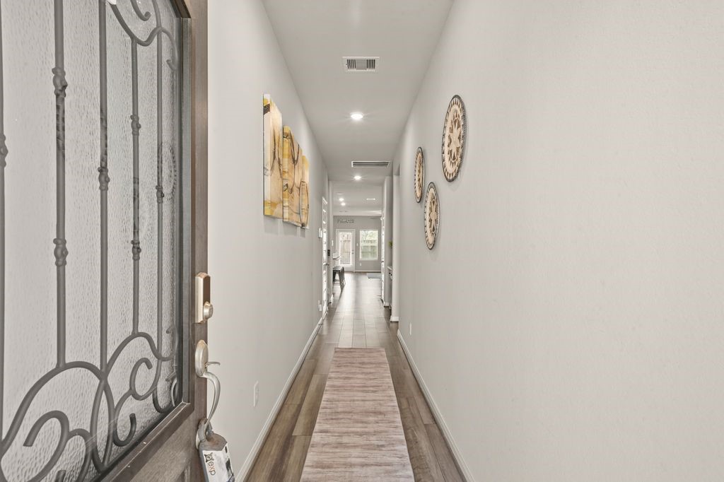 21727 Reserve Ranch Trail Richmond, TX 77407 - Photo 3 of 27 Entry Hallway: Bright entry with modern décor and sleek wood floors leading to the open living area.