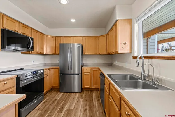 a kitchen with a sink and wooden cabinets