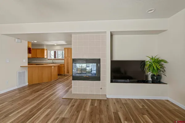 a kitchen with stainless steel appliances granite countertop a sink refrigerator and cabinets