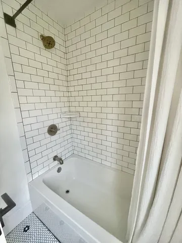 a view of a room with wooden floor and bathroom