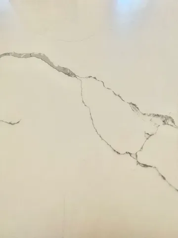 a view of kitchen with granite countertop lots of wooden cabinets and stainless steel appliances