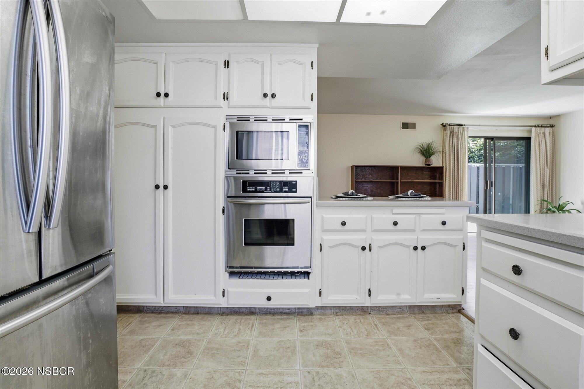 166 Tallyho Road Santa Maria, CA 93455 - Photo 8 of 20 a kitchen with stainless steel appliances white cabinets and a refrigerator