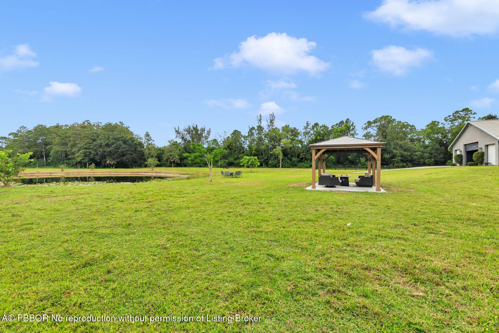 2770 E Road Loxahatchee, FL 33470 - Photo 43 of 51 a house view with a garden space