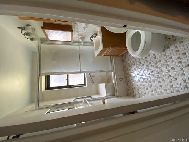 385 Grand Street, Unit L904 Manhattan, NY 10002 - Photo 3 of 6 Full bathroom with vanity and tiled shower