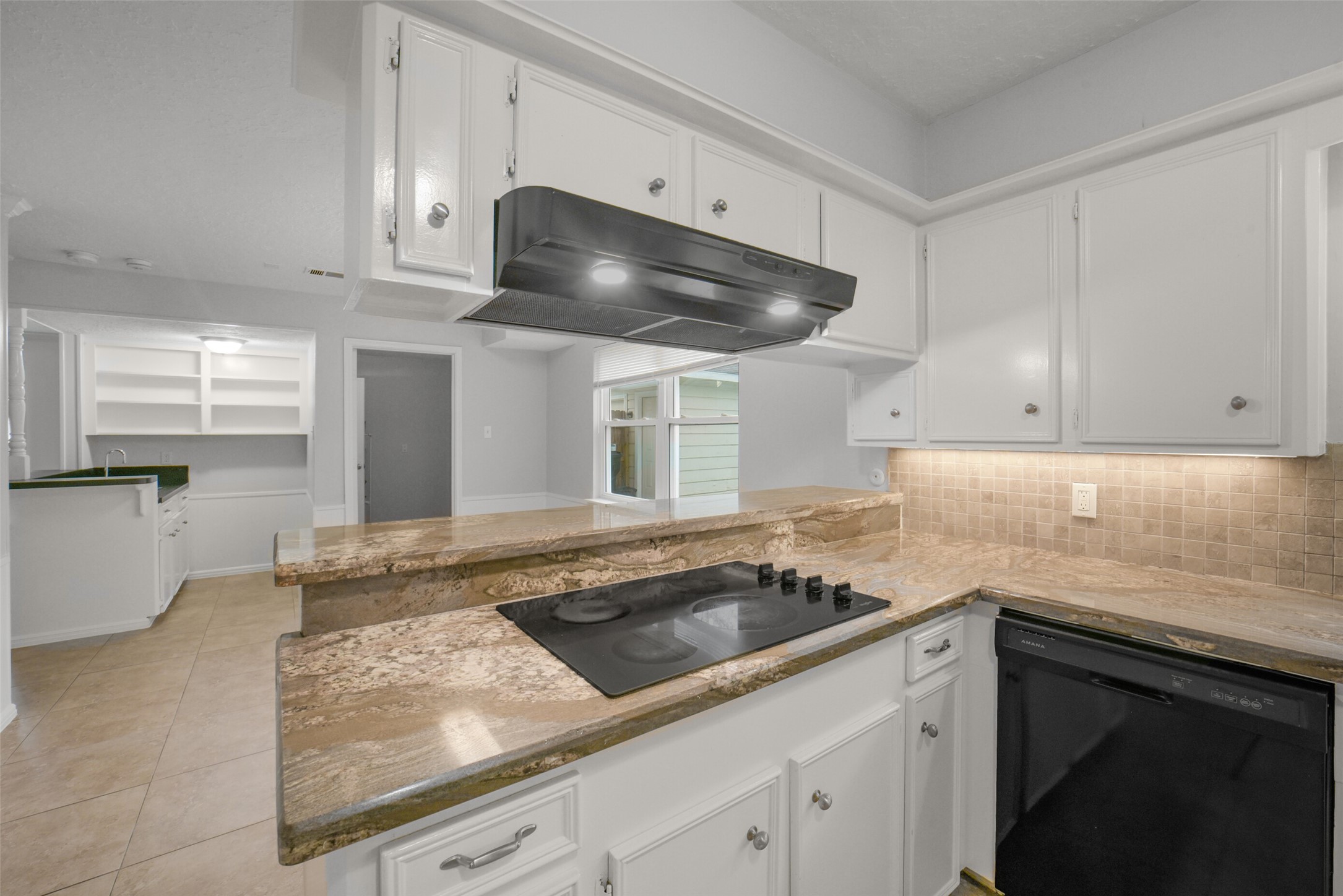 7611 Theisswood Road Spring, TX 77379 - Photo 11 of 41 a kitchen with granite countertop a sink and white cabinets