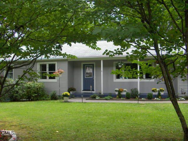a front view of house with yard and green space