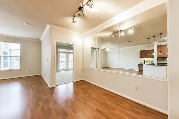 a view of a kitchen with wooden floor and a window