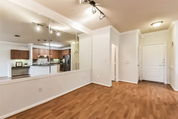 a view of a kitchen with wooden floor and electronic appliances