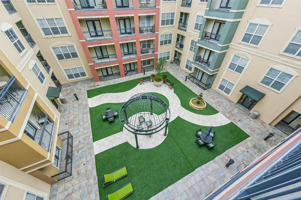 a front view of a residential apartment building with a yard