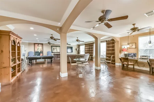 a living room with lots of furniture and a view of kitchen