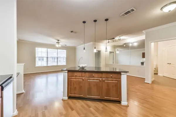 a large kitchen with lots of counter space sink and a refrigerator