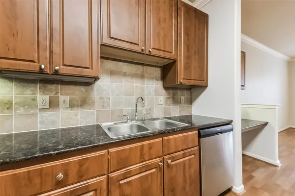a kitchen with stainless steel appliances granite countertop a sink and a cabinets
