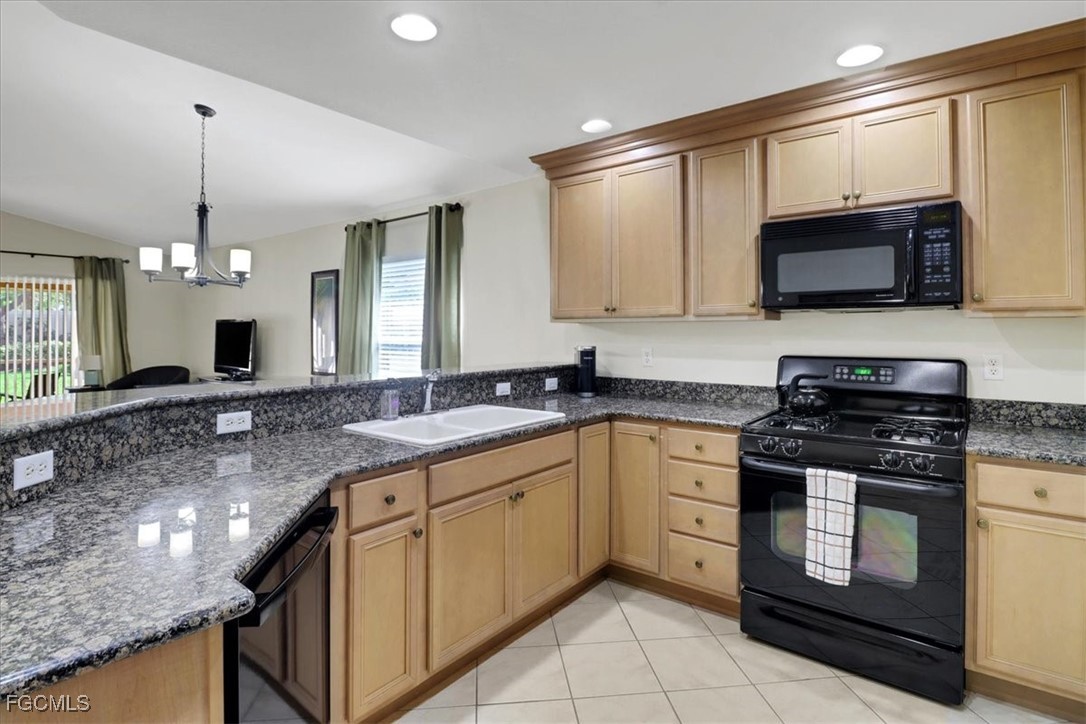 19674 Villa Rosa Loop Estero, FL 33967 - Photo 2 of 33 a kitchen with stainless steel appliances granite countertop a stove a sink and a microwave