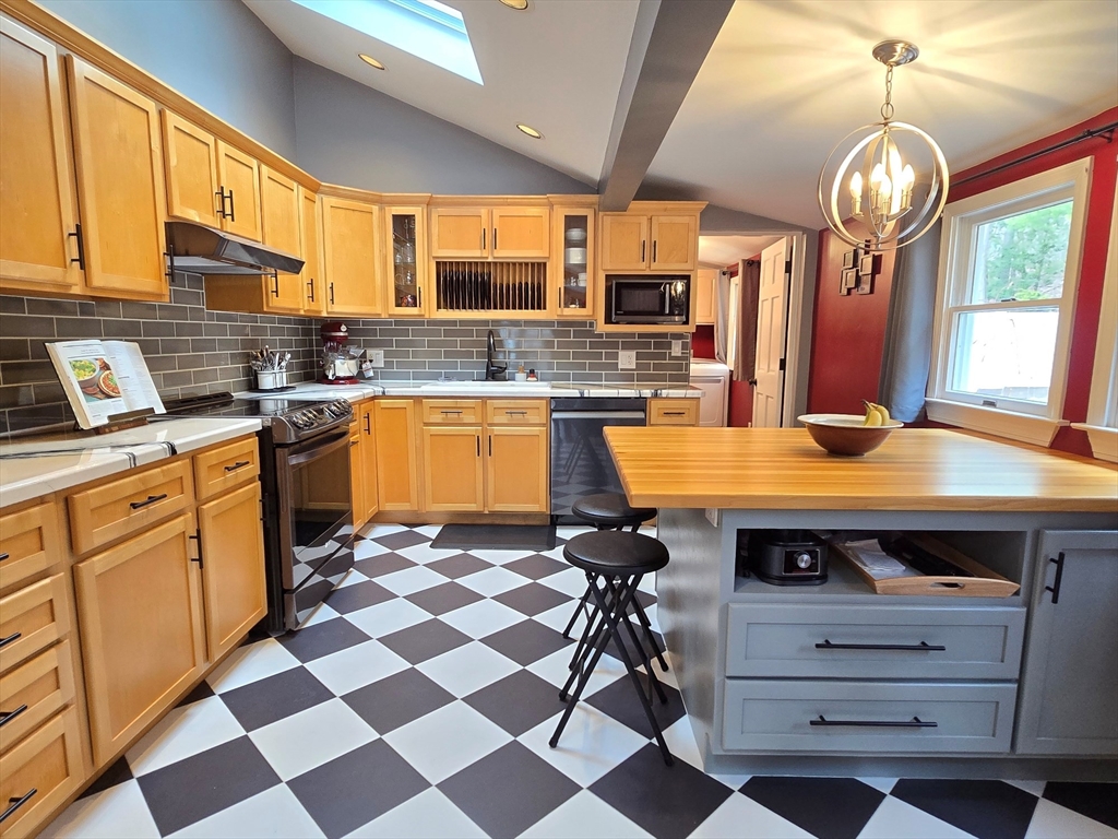 33 Pine Hill Road Ashland, MA 01721 - Photo 23 of 40 a kitchen with stainless steel appliances granite countertop a sink a stove and a refrigerator