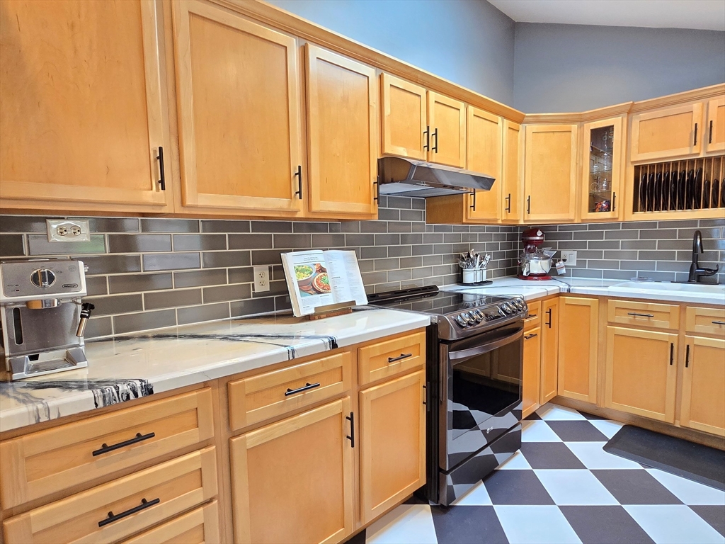 33 Pine Hill Road Ashland, MA 01721 - Photo 24 of 40 a kitchen with stainless steel appliances granite countertop a stove a sink and a microwave