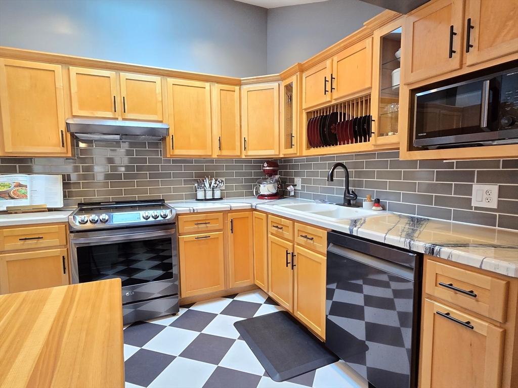 33 Pine Hill Road Ashland, MA 01721 - Photo 25 of 40 a kitchen with stainless steel appliances granite countertop a sink stove and cabinets