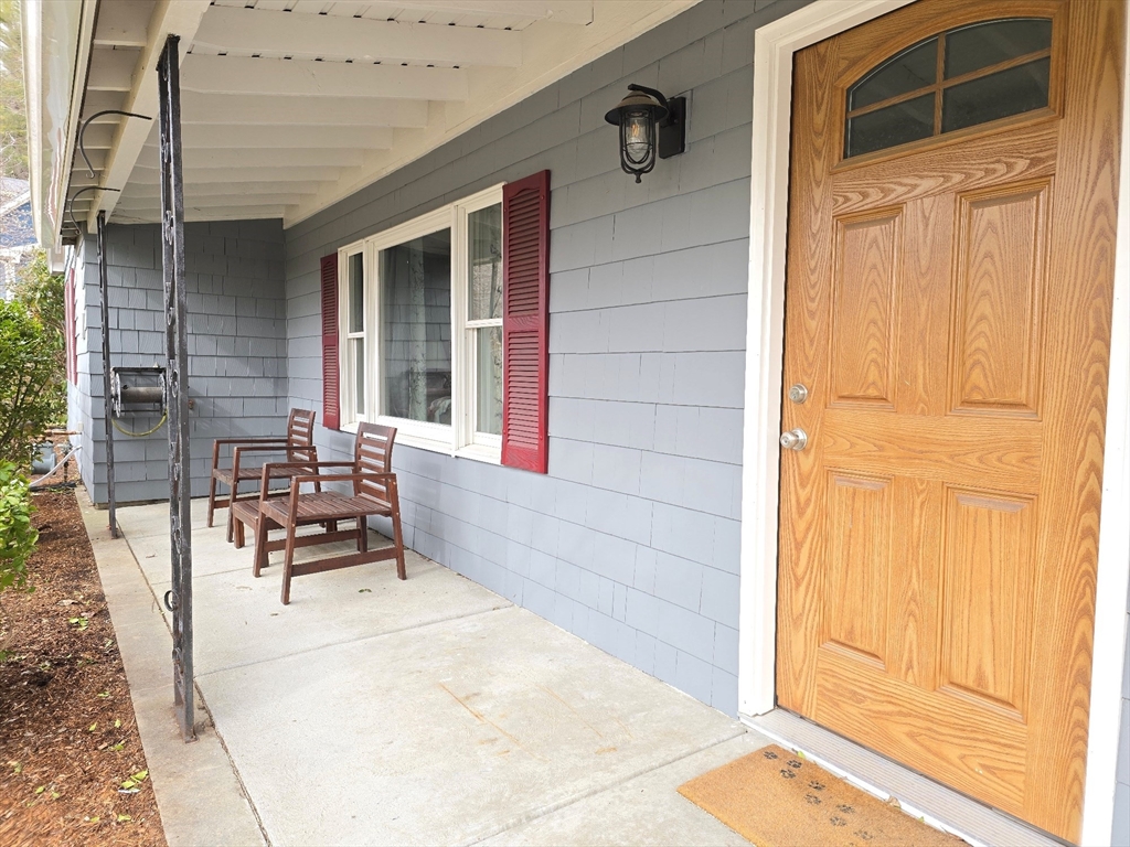 33 Pine Hill Road Ashland, MA 01721 - Photo 7 of 40 a balcony with table and chairs