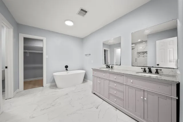 a bathroom with a bathtub and shower