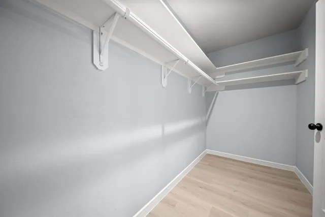 a spacious bathroom with a granite countertop sink mirror and bathtub