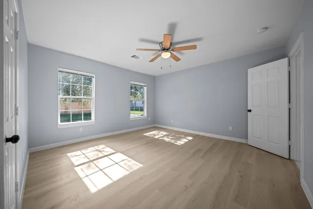 a view of a livingroom with a window and a ceiling fan