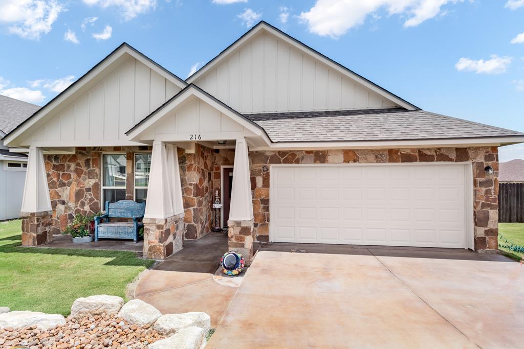 a view of a house with a yard and porch
