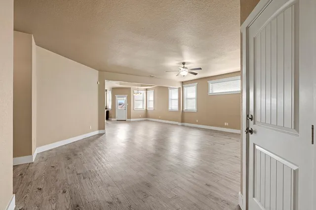 a view of a livingroom with wooden floor and window