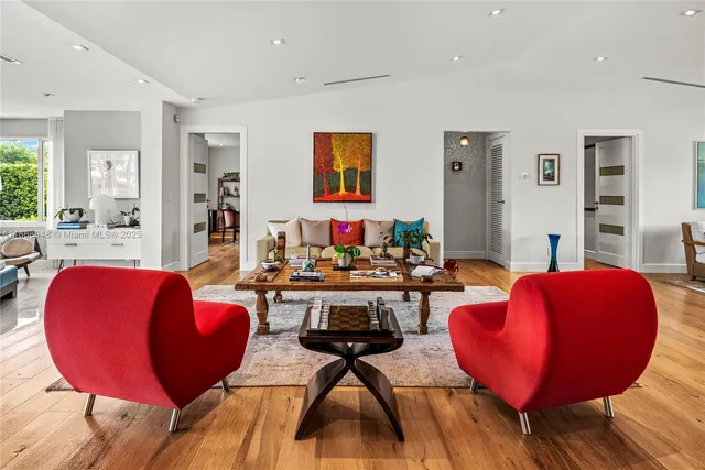 a living room with furniture and wooden floor
