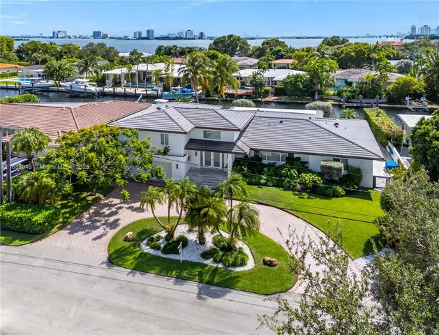 an aerial view of a house a garden and a swimming pool