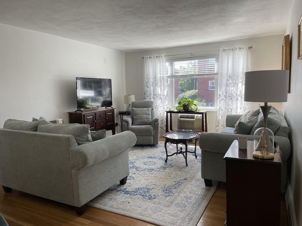 32 Whitman Road, Unit 12 Waltham, MA 02453 - Photo 9 of 19 a living room with furniture and a flat screen tv