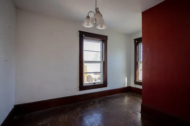 an empty room with windows and closet