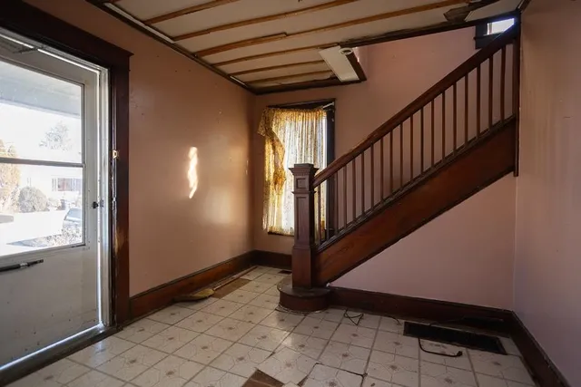 a view of entryway with wooden floor and stairs