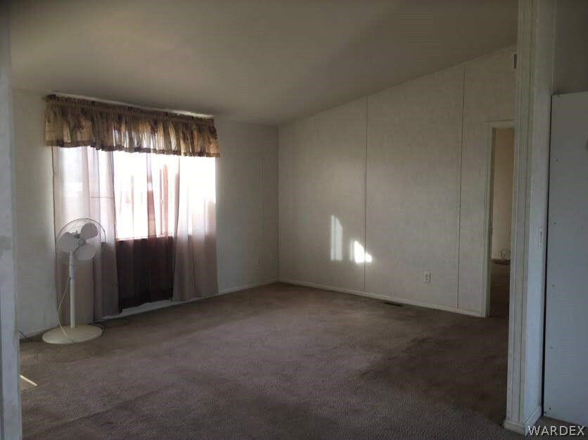 458 Heber Road Golden Valley, AZ 86413 - Photo 13 of 32 Spacious living room has vaulted ceilings and an open feel.