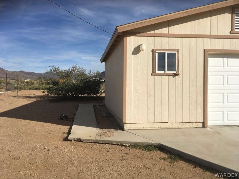 458 Heber Road Golden Valley, AZ 86413 - Photo 31 of 32 Lots of concrete including this walkway to the covered patio area behind the garage.