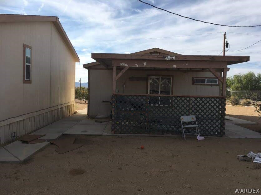 458 Heber Road Golden Valley, AZ 86413 - Photo 5 of 32 Covered patio area will be cleaned up soon and ready for your BBQ housewarming party!