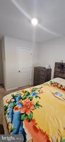 a bedroom with bed and mirror