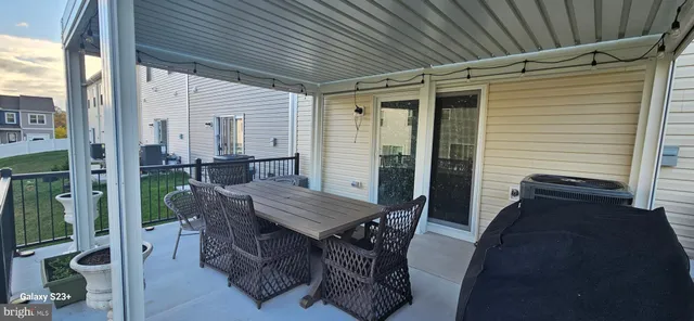 a view of a patio with table and chairs and potted plants