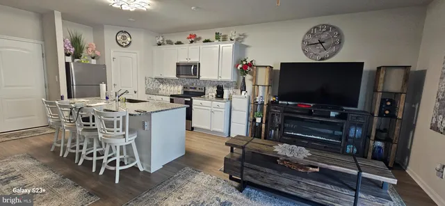 a view of a workspace with furniture and a flat screen tv