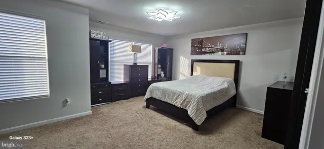 a bedroom with a bed and a closet with mirror