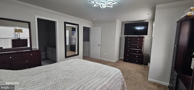 a bedroom with a bed and a television