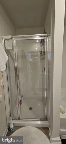 a bathroom with a glass shower door