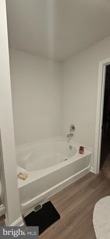 a bathroom with bathtub and a shower