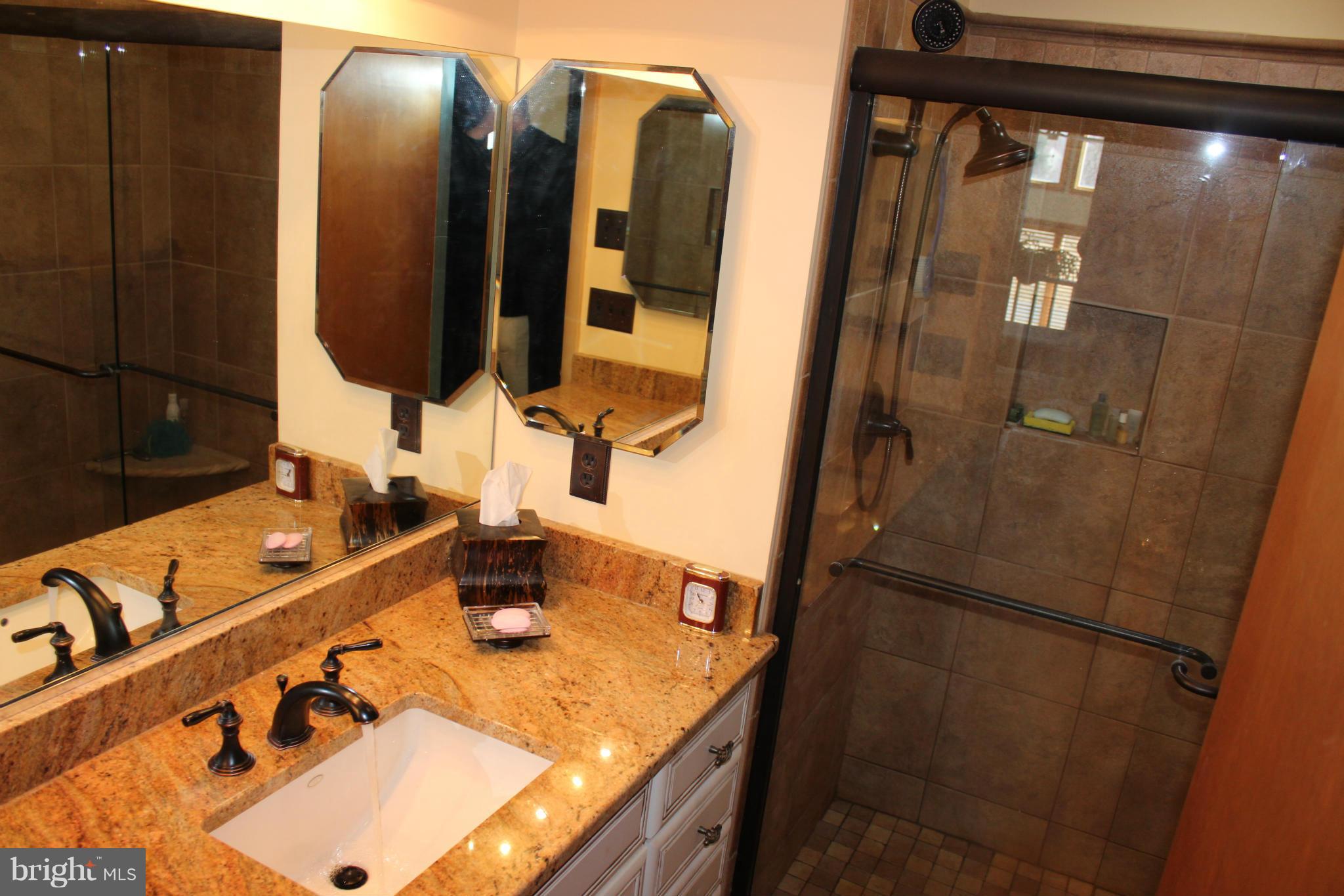 603 Old Point Road Chester, MD 21619 - Photo 22 of 30 a bathroom with mirror and shower