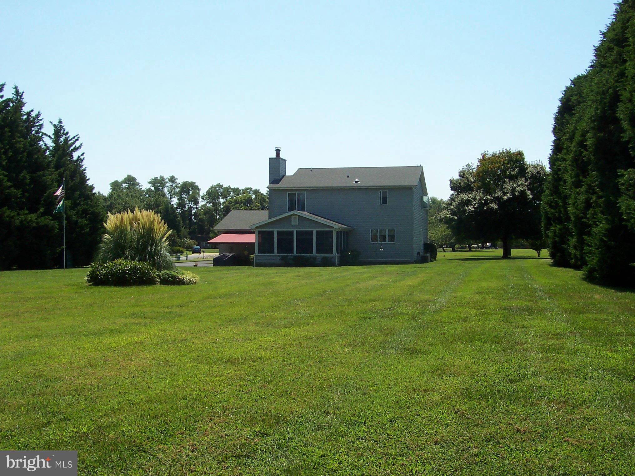603 Old Point Road Chester, MD 21619 - Photo 4 of 30 a front view of a house with a garden
