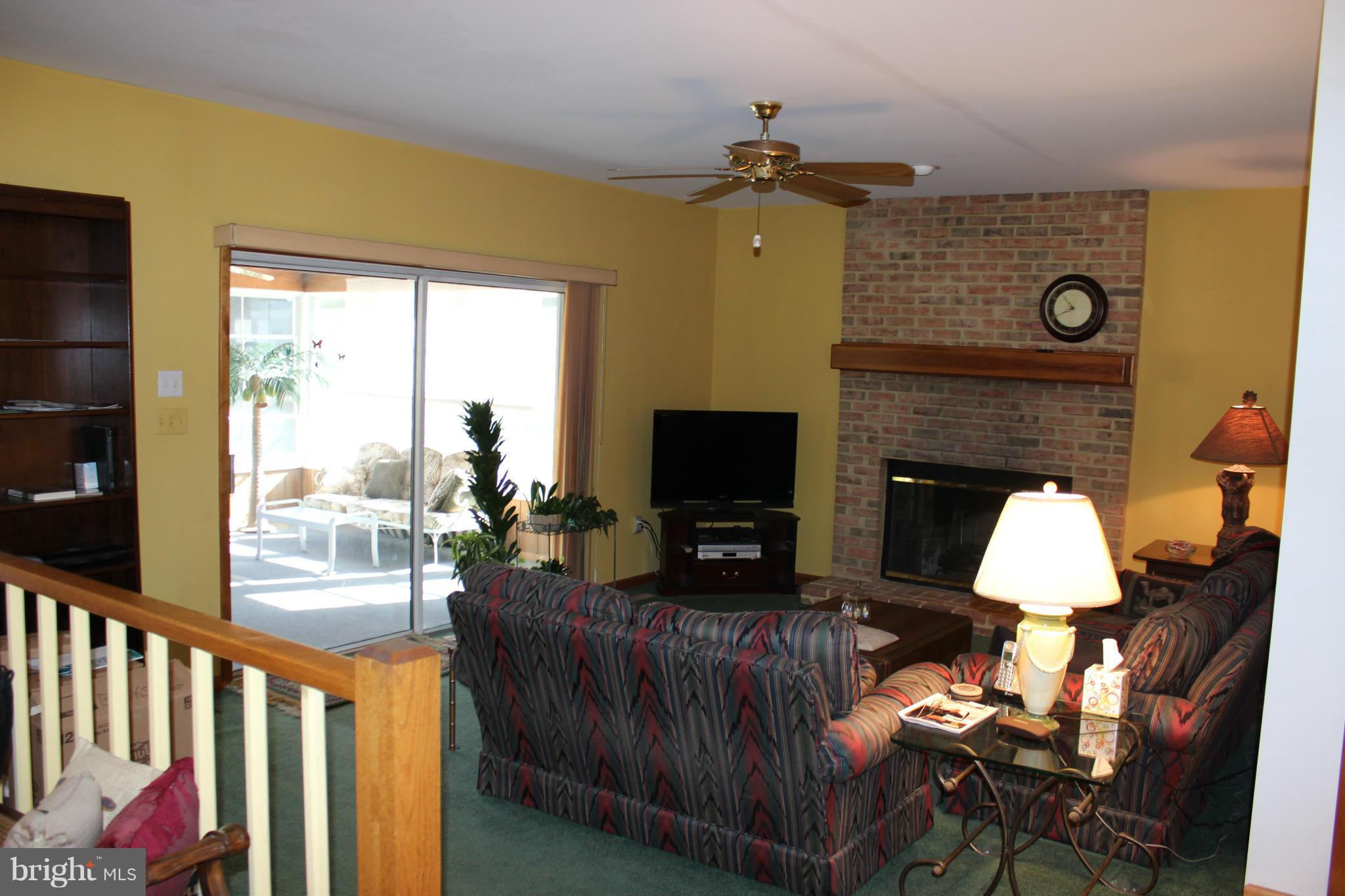 603 Old Point Road Chester, MD 21619 - Photo 7 of 30 a living room with furniture a fireplace and a flat screen tv