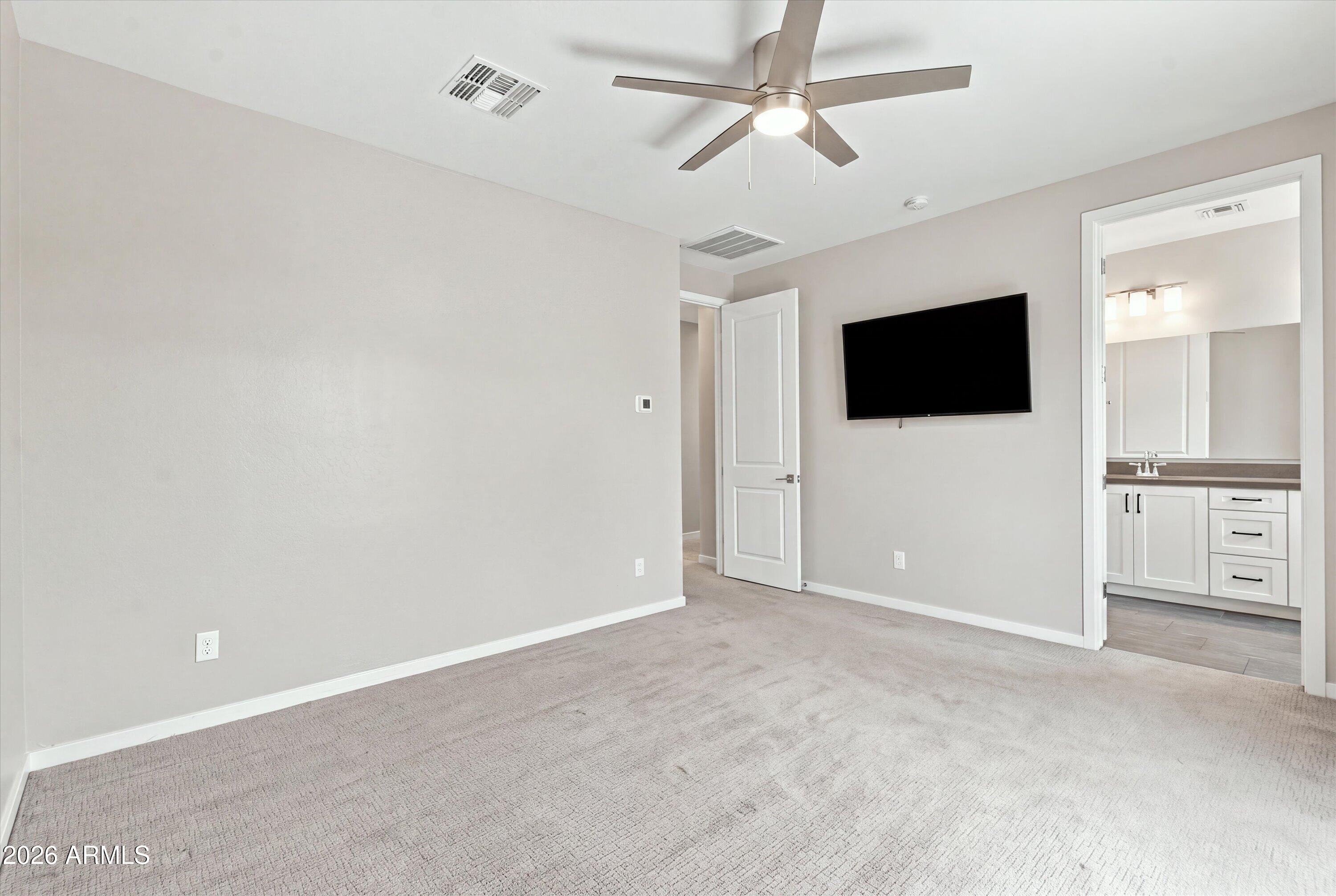 901 South Smith Road, Unit 1060 Tempe, AZ 85281 - Photo 15 of 33 Primary bedroom w/ mounted TV
