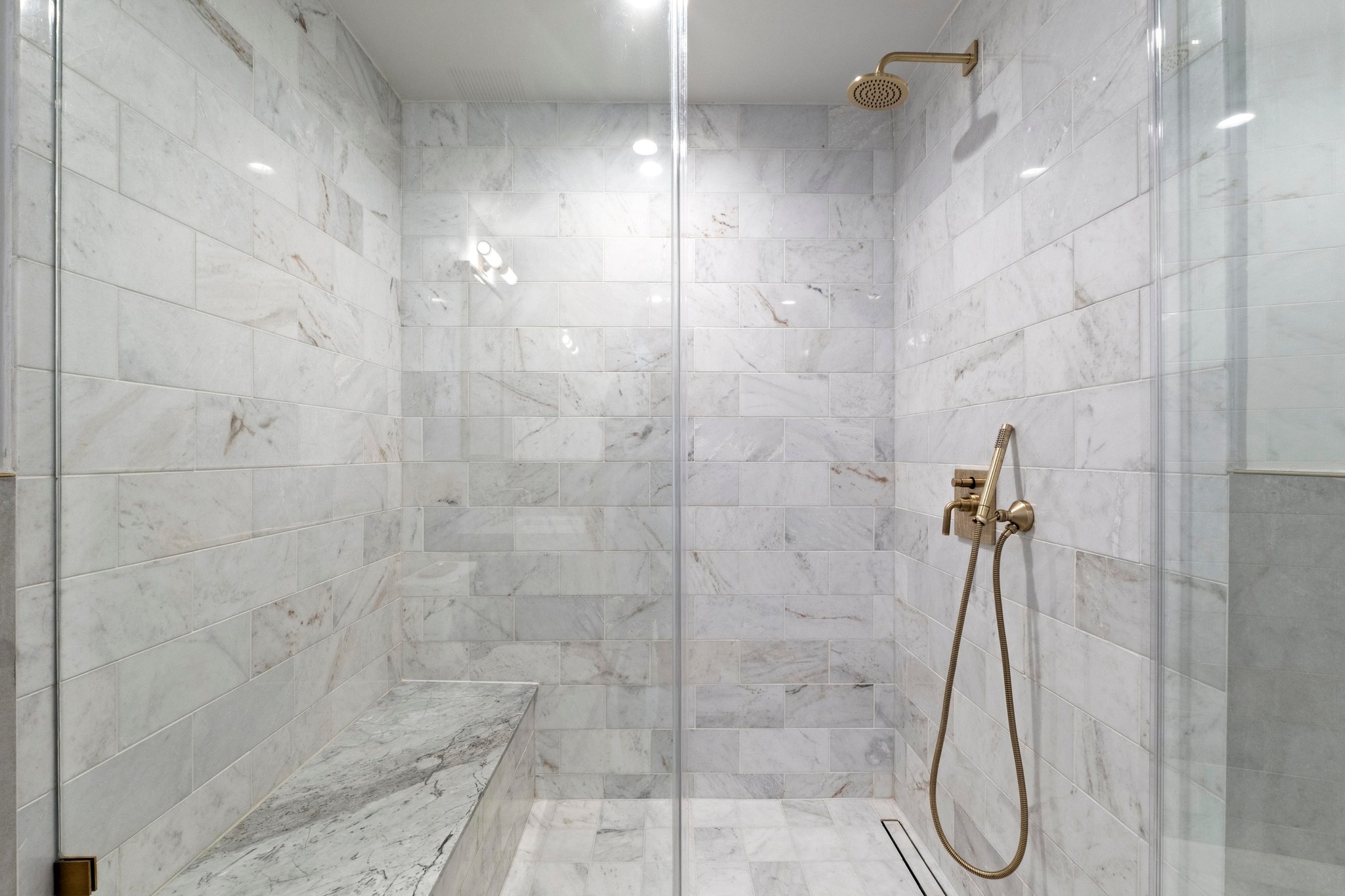70 Rainey Street, Unit 1303 Austin, TX 78701 - Photo 13 of 31 Walk-In shower with seating bench. Carrara marble tile.