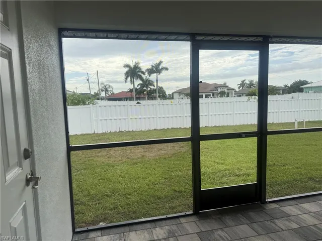 a view of a room with gym equipment and a large window